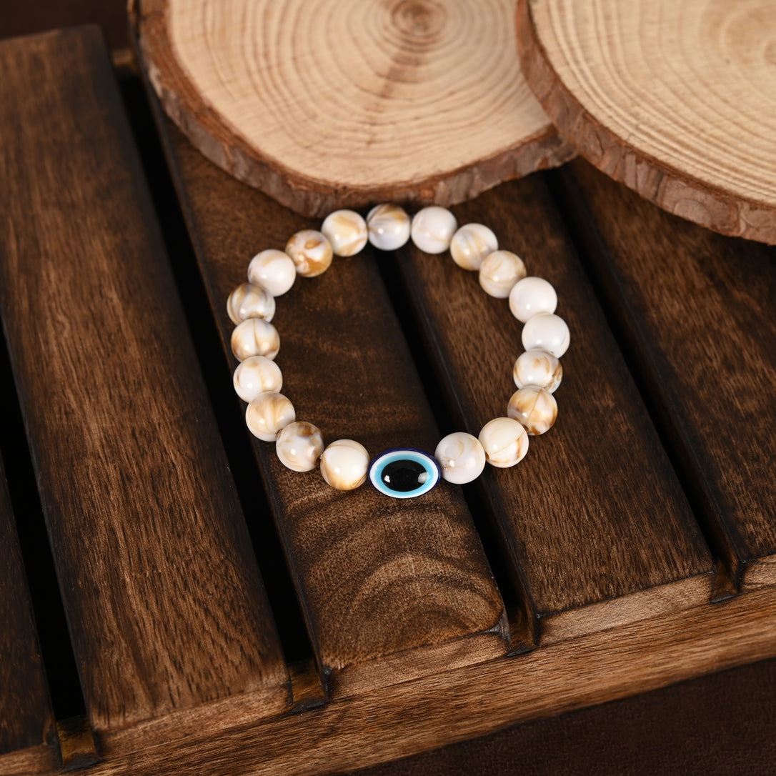 Cream-Colored Evil Eye Elasticated Rakhi With Roli Chawal