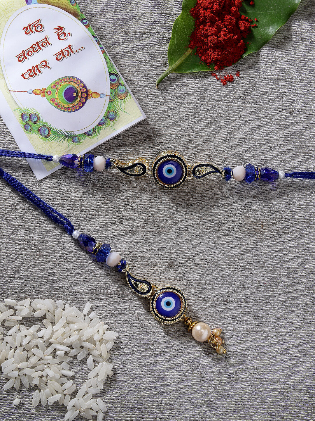 Set Of 2 Blue Evil Eye Beaded Bhaiya Bhabhi Rakhi With Roli Chawal & Chocolate