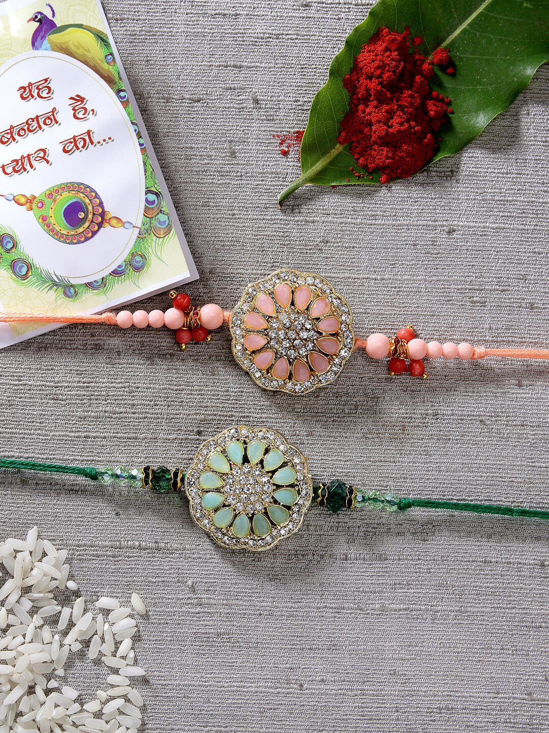 Set Of 2 Pink & Green Stone-Studded Rakhi With Roli Chawal