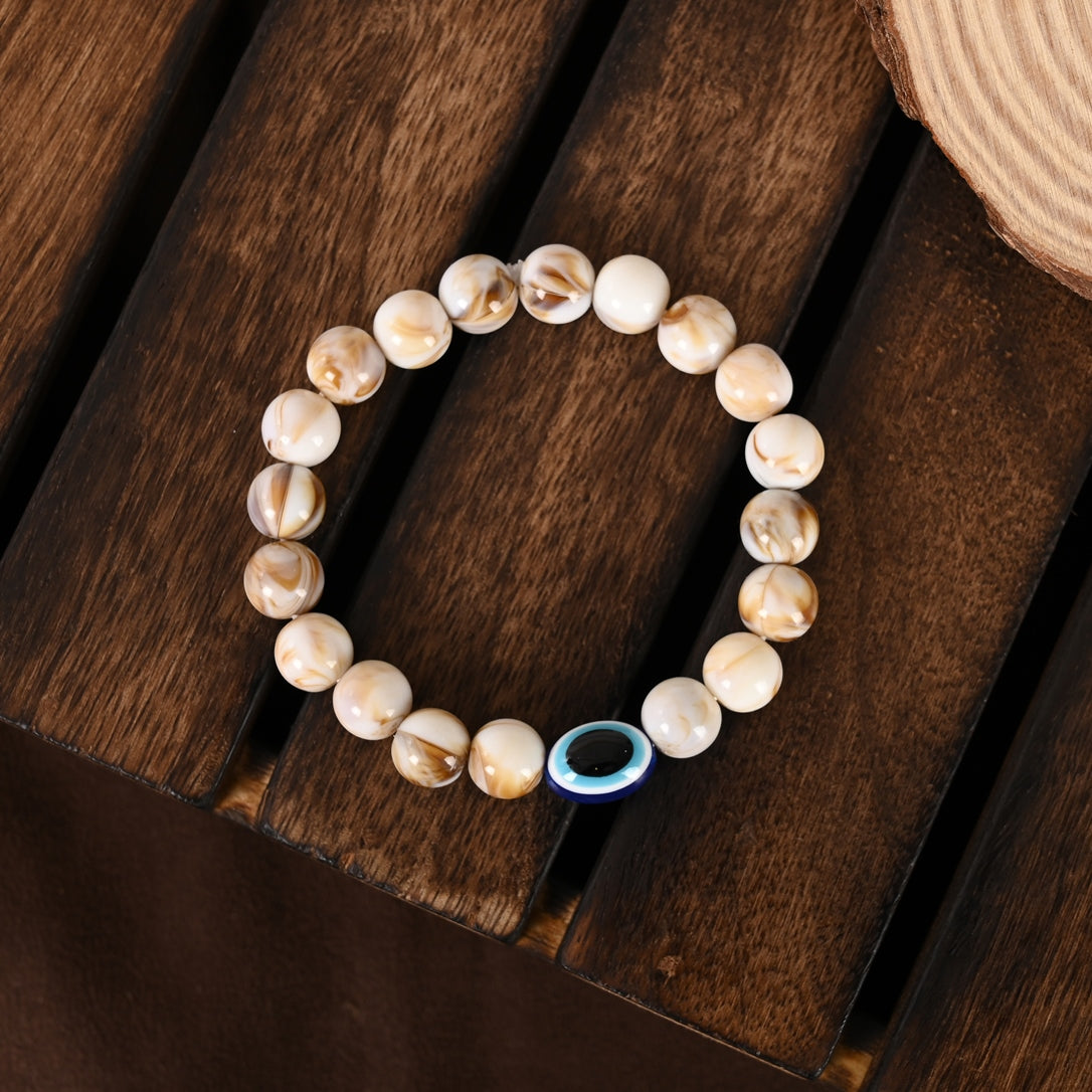 Cream-Colored Evil Eye Elasticated Rakhi With Roli Chawal