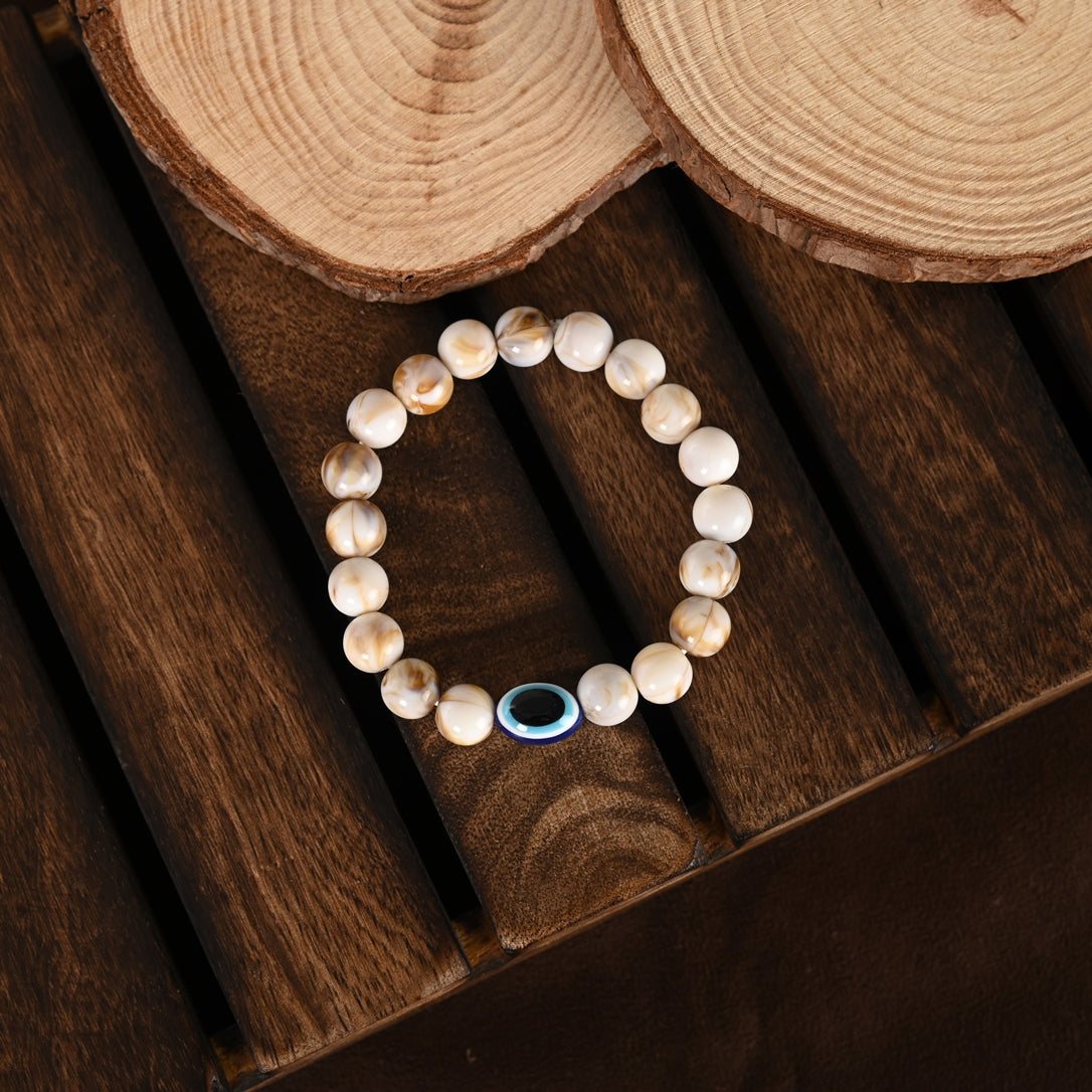 Cream-Colored Evil Eye Elasticated Rakhi With Roli Chawal