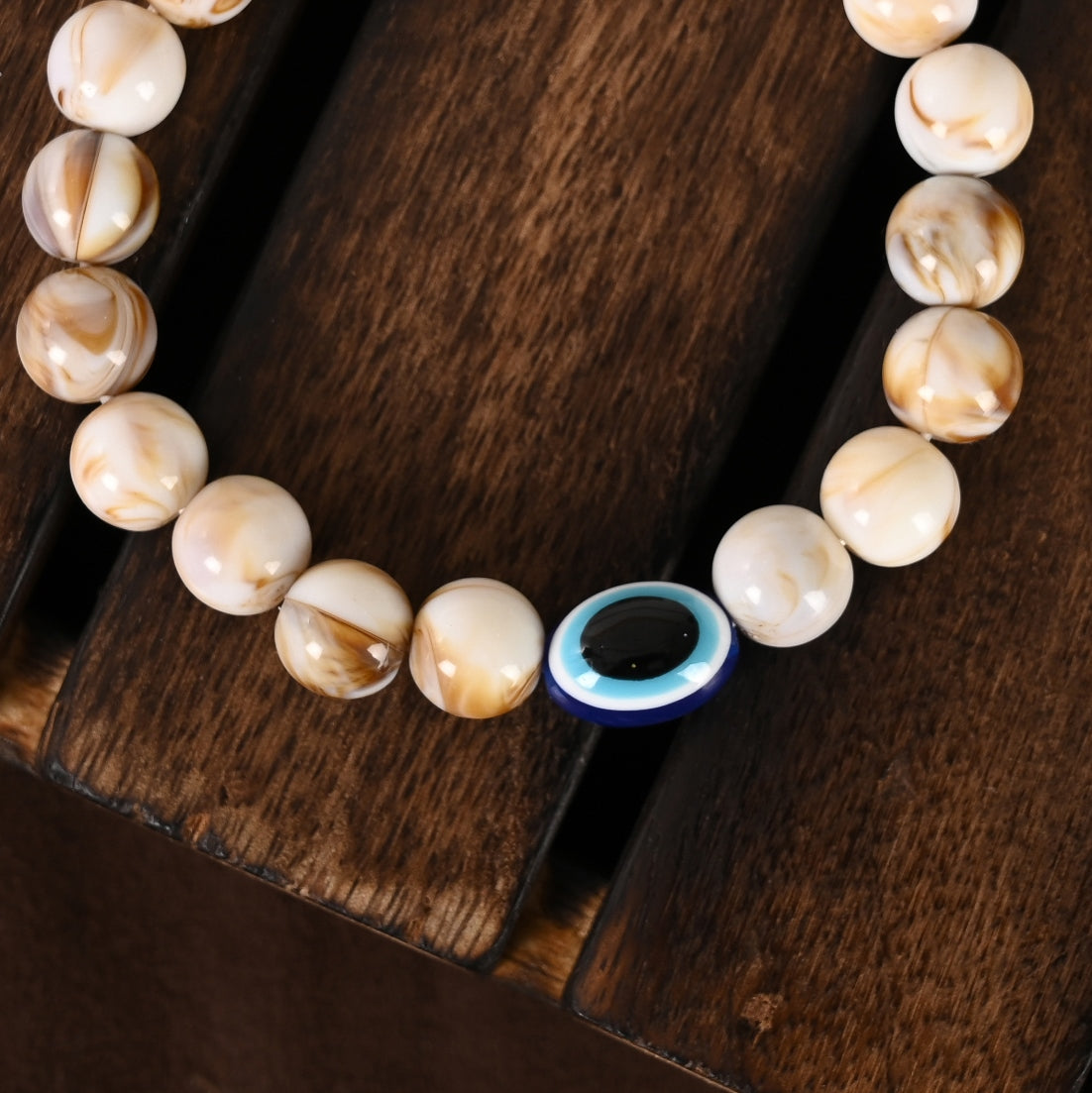 Cream-Colored Evil Eye Elasticated Rakhi With Roli Chawal