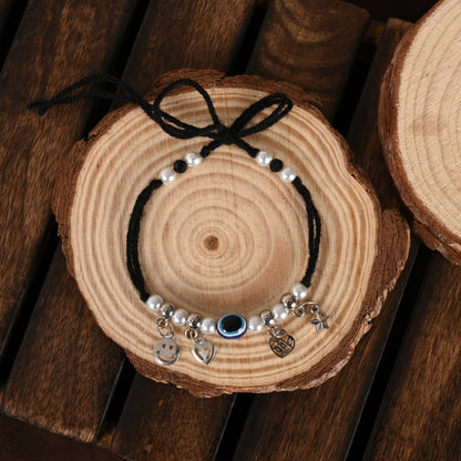 Set Of 2 Black Evil Eye Rakhi With Roli Chawal